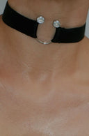 Black lingerie set with rhinestone accents on a neutral background
